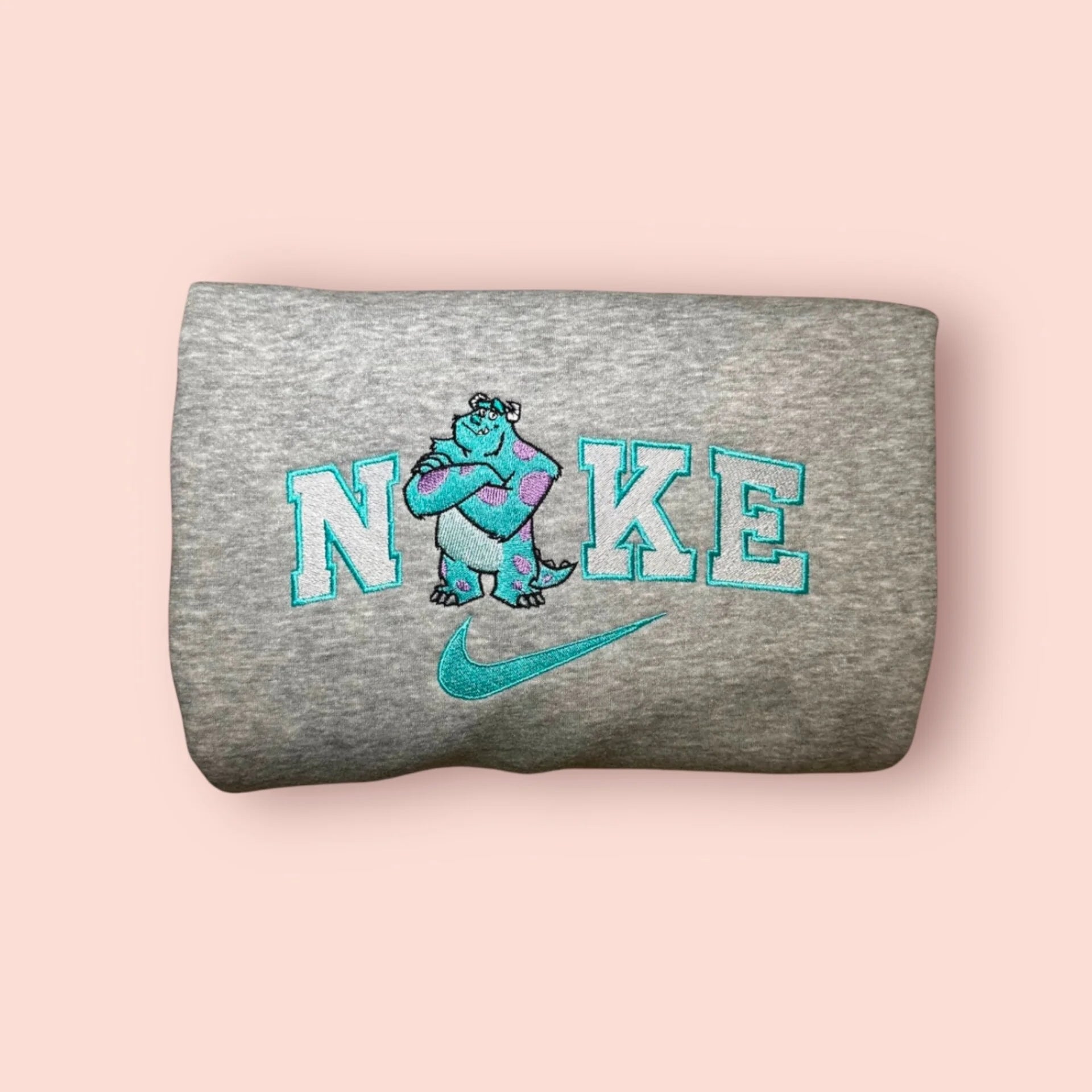 Sudadera gris con un bordado de alta calidad de James P. Sullivan (Sulley). El diseño en tonos turquesa y morado captura al "Asustador de Élite" con los brazos cruzados, integrado en el logo. Prenda de algodón suave, ideal para fans de Pixar. Compra esta sudadera junto a la de Mike para demostrar quién es tu "Kitty" favorito y formar el dúo más inseparable de Monstruópolis.